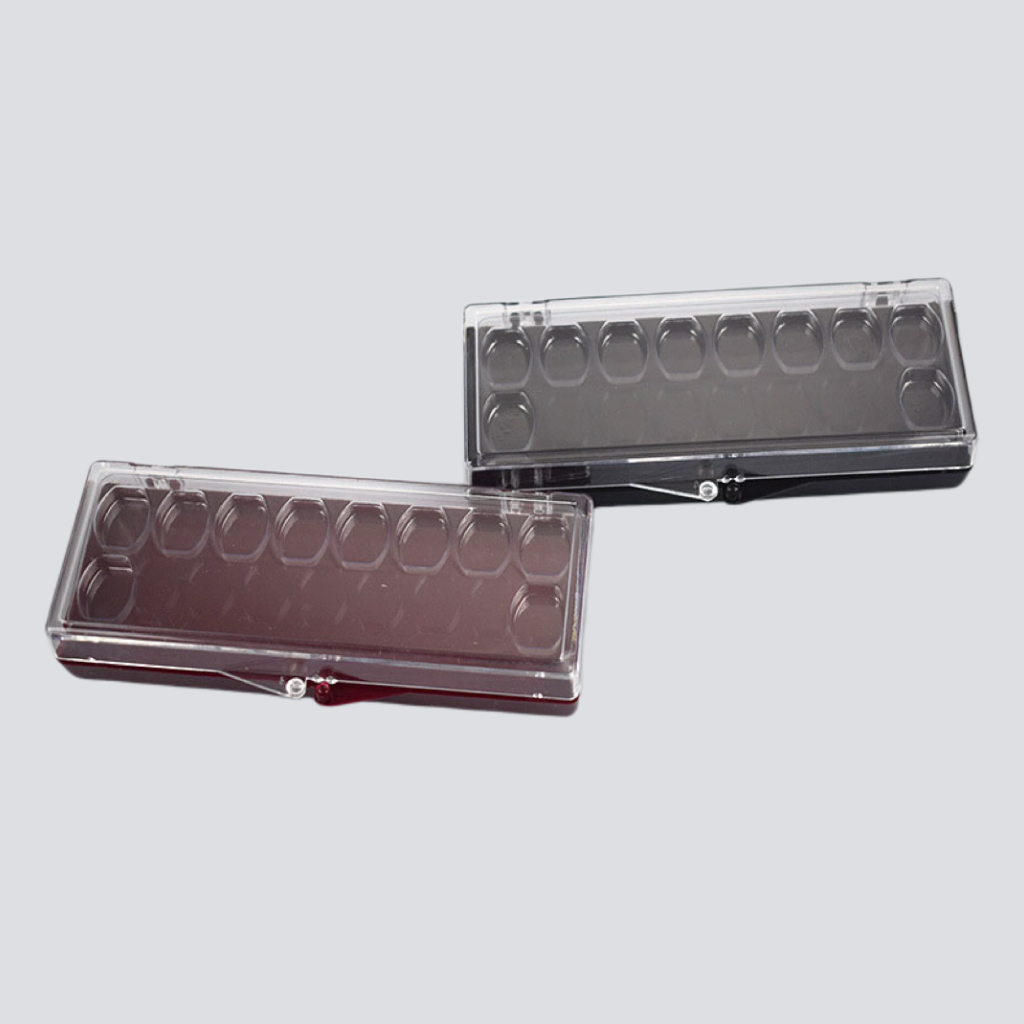 Two clear veneer membrane boxes with black and burgundy bases